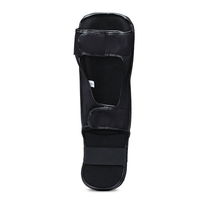 Black Xpeed XP3058 Matt PU grappling shinguard with padded design for protection during martial arts training.