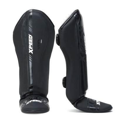 Black matte Xpeed XP3059 stand-up shinguard with padded protection and adjustable straps for secure fit.