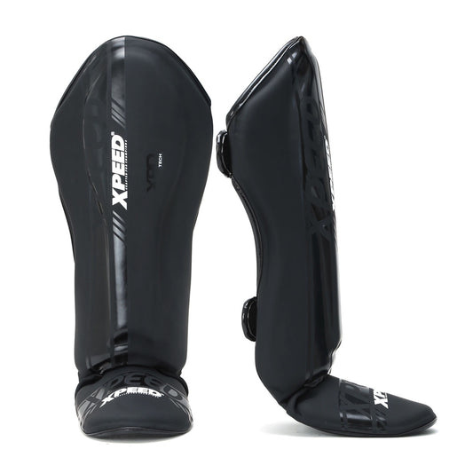 Black matte Xpeed XP3059 stand-up shinguard with padded protection and adjustable straps for secure fit.