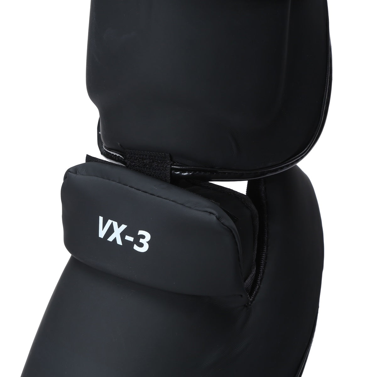 Xpeed XP3060 matte black PU shinpad with foot strap, designed for protective sports gear, featuring a sleek matte finish.