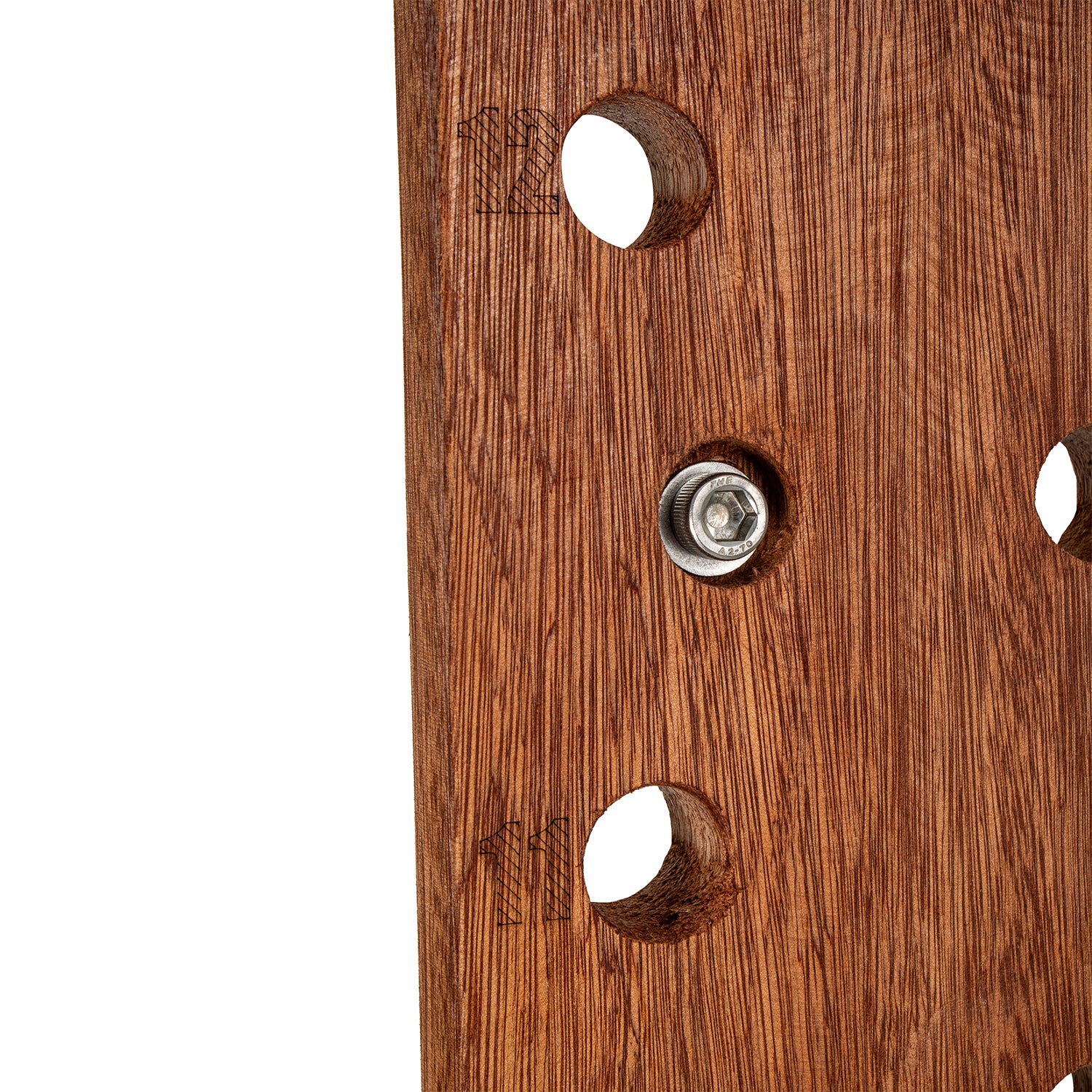 Close-up of a brown wooden panel with three circular cutouts and a central metal mounting screw, shown against a white background.