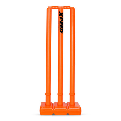 Bright orange plastic cricket stumps with a black 'XPEED' logo printed vertically on the center stump, set against a plain white background.