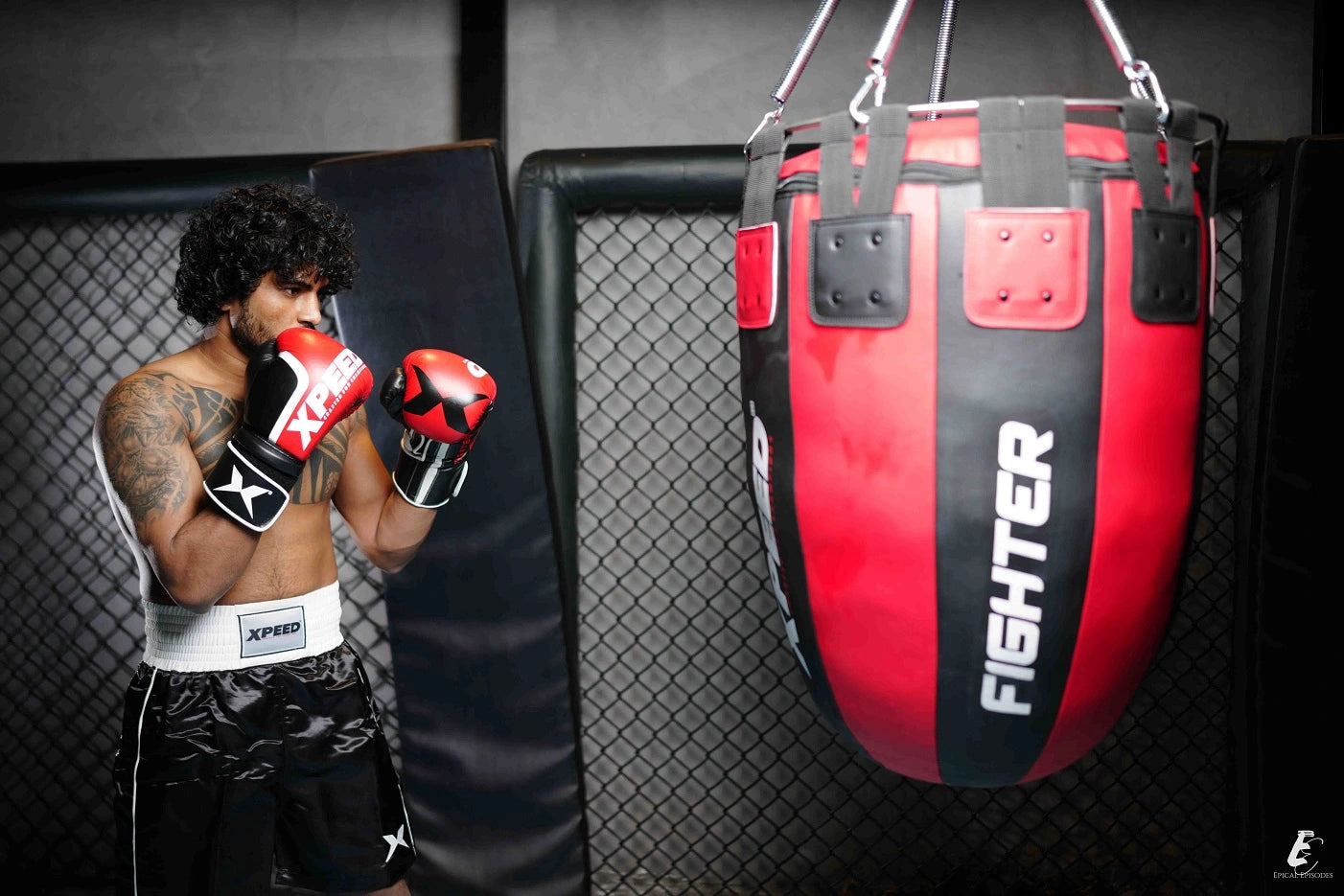 Boxer training with heavy punching bag - Xpeed combat sports equipment